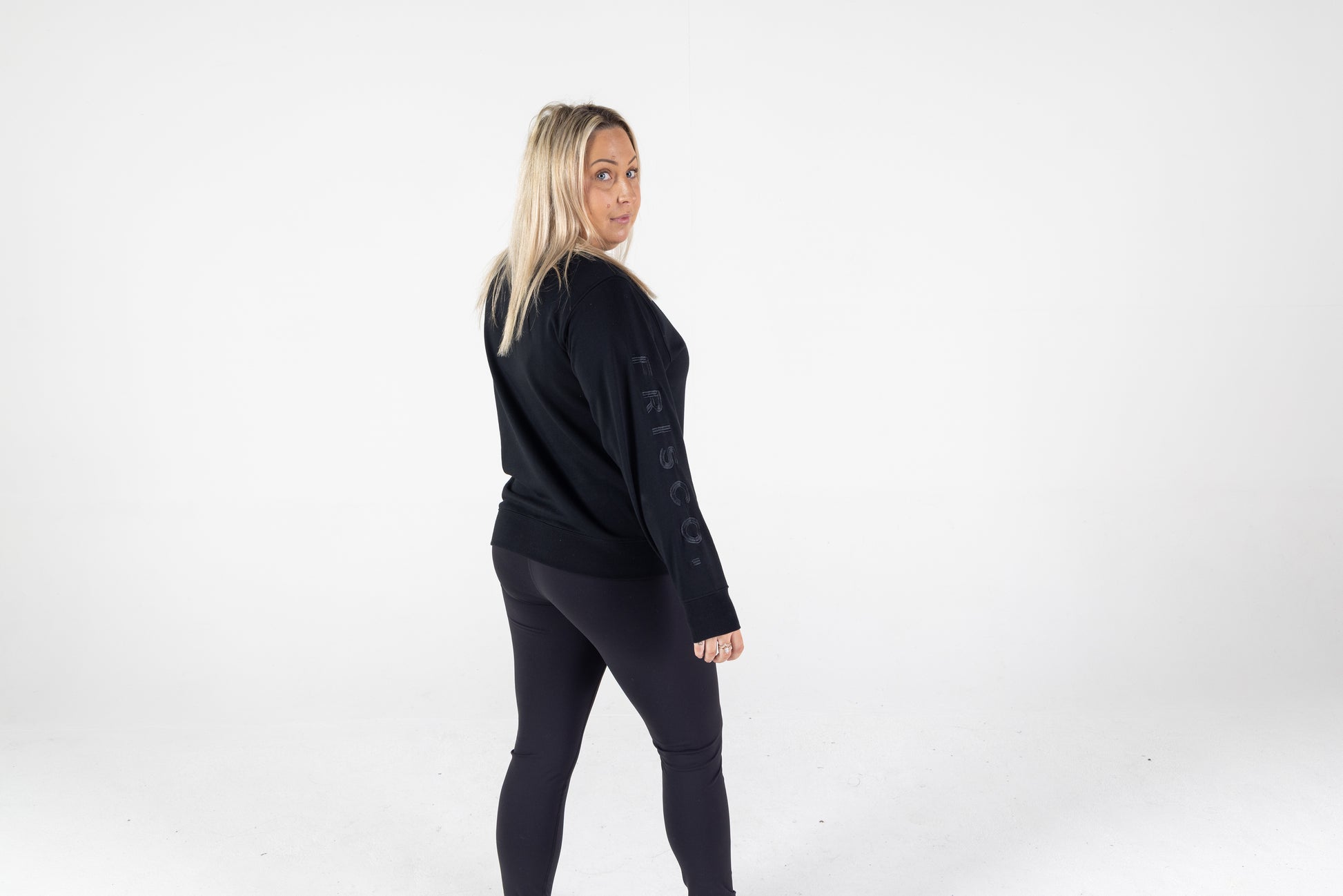 Frisco Women's activewear XL longsleeve crew top in black with black embroidery, shown from behind