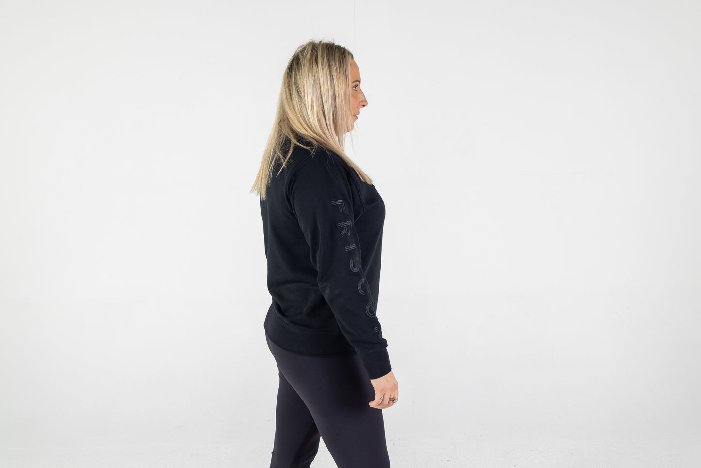 Frisco Women's activewear XL longsleeve crew top in black with black embroidery, shown from side