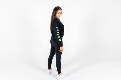 "Frisco Women's activewear small longsleeve crew top in black with green embroidery, shown from side "