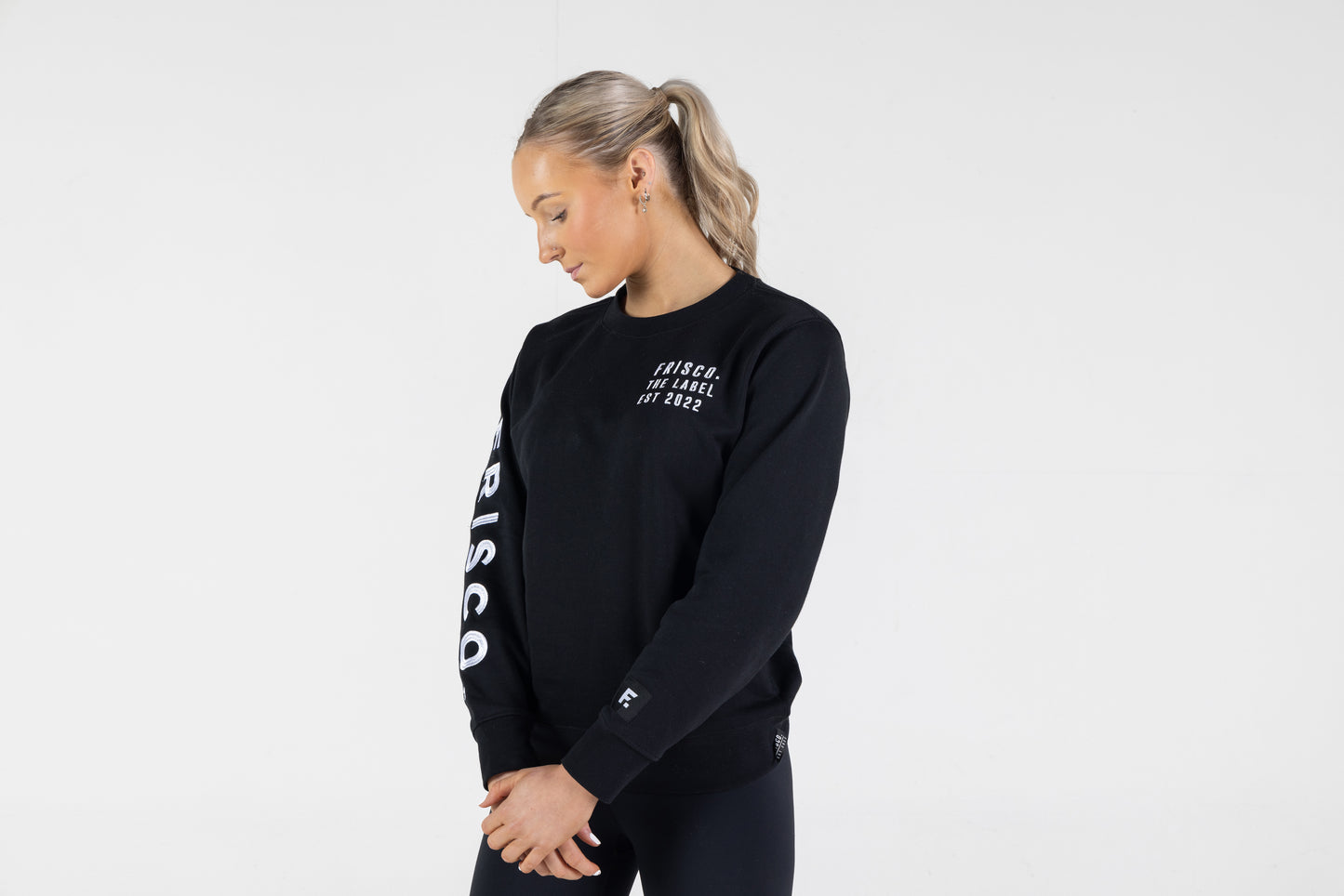 Frisco Women's activewear small longsleeve crew top in black with white embroidery, shown from front