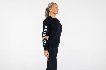 "Frisco Women's activewear small longsleeve crew top in black with white embroidery, model shown from right side "